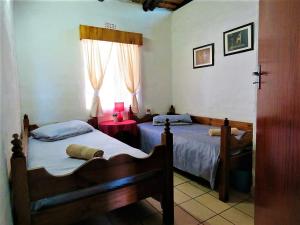 A bed or beds in a room at Impala Niezel Lodge & Guest House