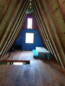 a room with a mattress in the middle of a tent at Chalé Roots in São Thomé das Letras