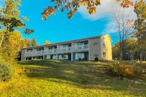 a building on top of a grassy hill at Glenghorm Beach Resort in Ingonish