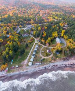 an aerial view of a parking lot next to the ocean at Glenghorm Beach Resort in Ingonish