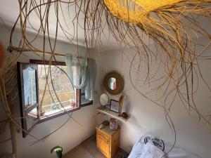 a room with a bunch of branches hanging from the ceiling at We surf Morocco BOUTIQUE HOUSE in Taghazout