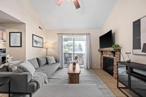 a living room with a couch and a fireplace at Cozy Top Floor Condo with Mountain Views in Park City