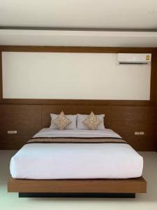 a bedroom with a large bed with white sheets at Vipa Tropical Resort in Ao Nang Beach