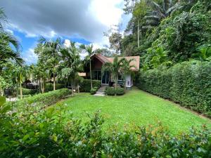 a house with a lawn in front of it at Vipa Tropical Resort in Ao Nang Beach