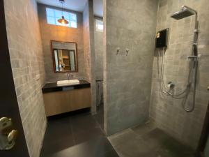 La salle de bains est pourvue d'une douche et d'un lavabo. dans l'établissement Vipa Tropical Resort, à Ao Nang Beach
