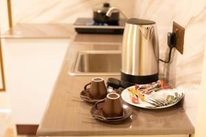 a kitchen counter with a coffee maker on a table at Relax Villa in Thoddoo