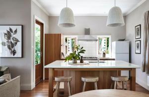a kitchen with a large island with bar stools at Milk and Honey in Daylesford