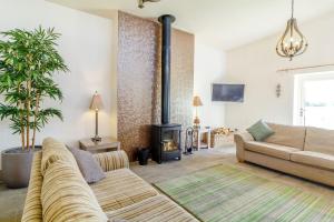 a living room with a couch and a fire place at The Croft in Great Malvern
