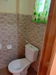 a bathroom with a white toilet and a window at RedDoorz at Solid Rock Guest House Dipaculao Aurora in Dipaculao +16 photos
