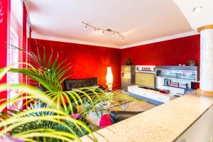 a living room with a red wall at Ferienwohnung Köln Messenähe in Cologne