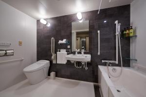 大阪市にあるWelina Hotel Shinsaibashi NAGOMIのトイレ、洗面台、浴槽を備えたバスルーム