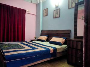 a bedroom with a bed and a red curtain at Entire Furnished Two bedrooms Apartment Ground Floor with kitchen in Karachi