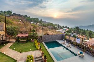 an aerial view of a house with a swimming pool at SaffronStays Cinco Elementos, Panchgani - stunning valley view pool villa in Panchgani