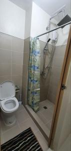 a bathroom with a toilet and a shower at 05-06 at Wind Residences Tagaytay in Tagaytay