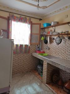 a kitchen with a counter and a window at Dar rachid ouzoud in Azilal