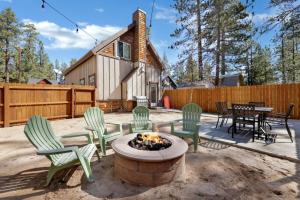 a patio with chairs and a fire pit in front of a house at Village Chic Chalet #2113 by Big Bear Vacations in Big Bear Lake