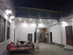 a room with a bed in the middle of a building at Al-Bashir in Bukhara