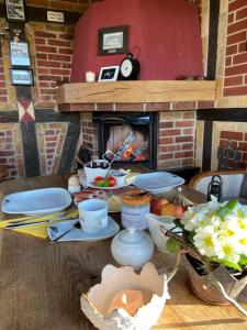 a table with food and a fireplace in a room at St.Moritz -Quadenschönfeld in Möllenbeck