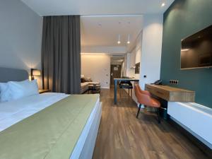 a hotel room with a bed and a desk at Golden Horn Apart Hotel in Baku