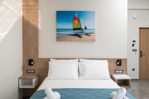 a bedroom with a bed with a sailboat on the beach at Archin Boutique suites in Chania