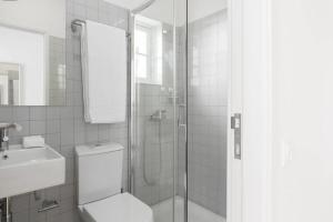 a bathroom with a shower and a toilet and a sink at GuestReady - Costa Cabral Guesthouse Room 4 in Porto