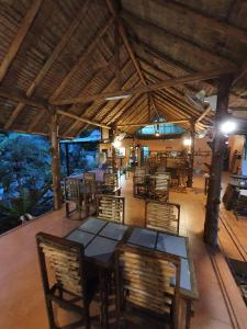 a dining area with tables and chairs in a restaurant at Bamboo Hideaway, Bungalows with Pool and Kitchen in Ko Mak