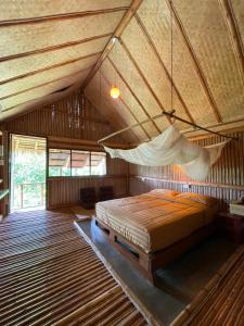 a large bedroom with a bed in a roof at Bamboo Hideaway, Bungalows with Pool and Kitchen in Ko Mak