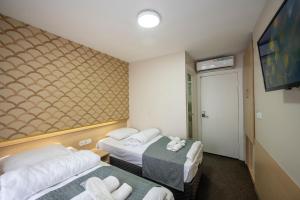 Postel nebo postele na pokoji v ubytování Hotel Melita