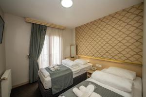 Postel nebo postele na pokoji v ubytování Hotel Melita