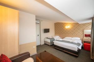 Postel nebo postele na pokoji v ubytování Hotel Melita