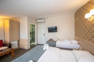 Postel nebo postele na pokoji v ubytování Hotel Melita