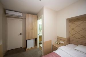 Postel nebo postele na pokoji v ubytování Hotel Melita + 37 fotografií
