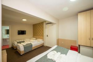 Postel nebo postele na pokoji v ubytování Hotel Melita