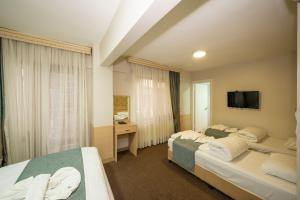 Postel nebo postele na pokoji v ubytování Hotel Melita