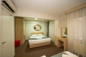 Postel nebo postele na pokoji v ubytování Hotel Melita