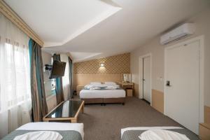 Postel nebo postele na pokoji v ubytování Hotel Melita
