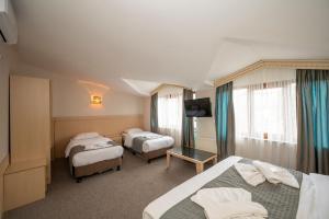 Postel nebo postele na pokoji v ubytování Hotel Melita
