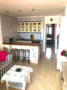 a kitchen and living room with a couch and a table at Casa Joe, cosy one bedroom apartment on popular complex with pool in Tías