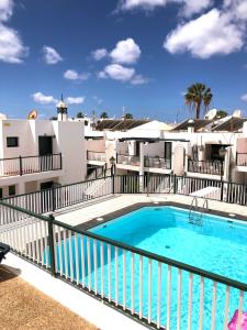 a swimming pool on the balcony of a apartment at Casa Joe, cosy one bedroom apartment on popular complex with pool in Tías