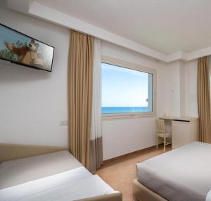 Posteľ alebo postele v izbe v ubytovaní Hotel Trevi - Cattolica Family Resort