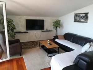 un soggiorno con divano e TV di Holiday Home Marincello a Solin (Salona)