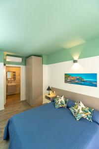 a bedroom with a blue bed with two pillows at TwoWays5Terre in La Spezia