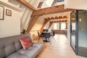 a living room with a couch and a table at The Hendrik Square Apartments in Antwerp