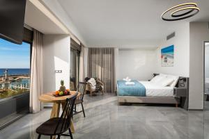 a hotel room with a bed and a table with a tablektop at Archin Boutique suites in Chania