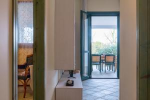 a hallway with a door leading to a dining room at Blue Sea - Villa Aquilone by Wonderful Italy in Ostuni +13 photos