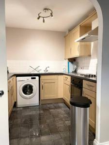 a kitchen with a washer and dryer in it at BEST PRICE! Huge 1 bed Apartment, City Centre, Single Beds or Super King, Sofabed & FREE SECURE PARKING in Southampton