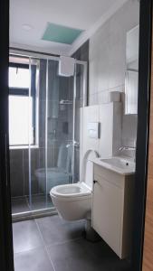 a bathroom with a toilet and a sink and a shower at ÇALIŞKANLAR OTEL in Canakkale +23 photos