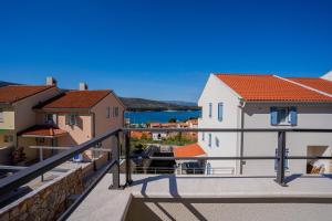 a view of the water from the balcony of a house at Sunset Apartment in Cres