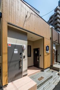 a building with its doors open on a street at HANASTAY花渓居 · 海（UMI) in Osaka