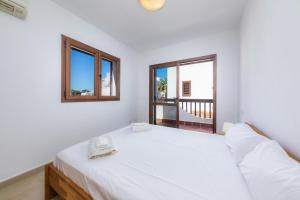 a bedroom with a white bed with a phone on it at LA PERLA DE CALA DOR in Portopetro +36 photos